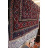 A Turkish rug 115 x 175cm and another Middle Eastern example with geometric red ground 110 x 140cm