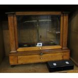 A mahogany cased chemist scale and a box of brass weights