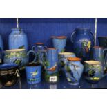 Torquay Long Park pottery to include a pair of vases, jugs, candlestick and bowls, each decorated