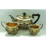 A Queen Anne style silver teapot, sugar bowl and milk jug, 23 troy oz in total.