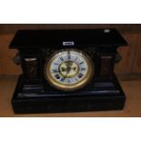 A black metal cased mantel clock with lion head mounts Asonia Clock Co., New York, 25cm high