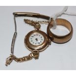 A wedding ring, marked 750 and a ladies wristwatch, marked 365 on gold coloured bracelet