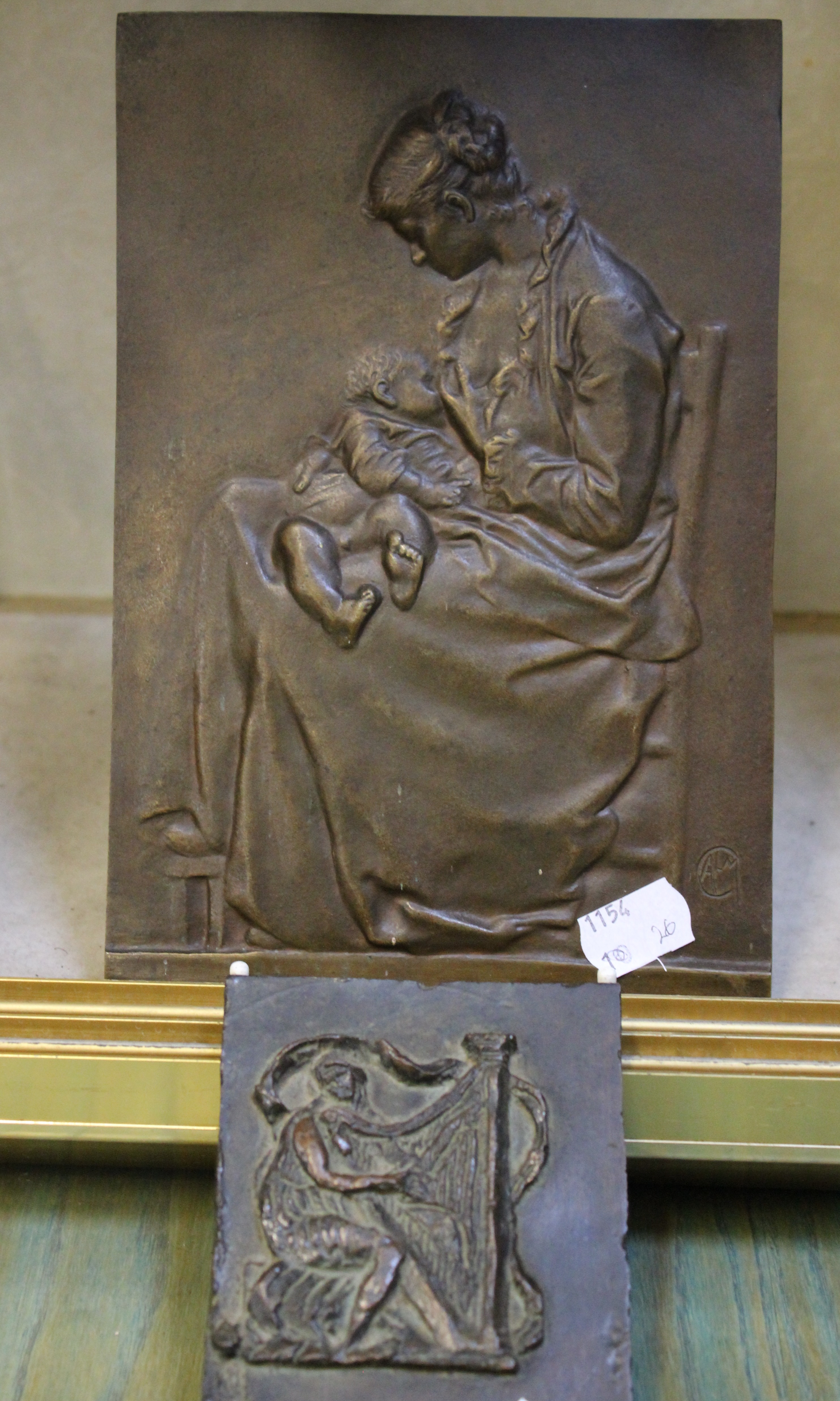 Two Bronze Plaques, French School (), A Mother breast feeding her baby signed CALM lower right