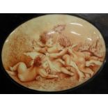 An oval painted porcelain plaque, depicting cherubs, framed, 18cm x 23cm