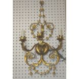 A modern gold decorated three branch wall sconce