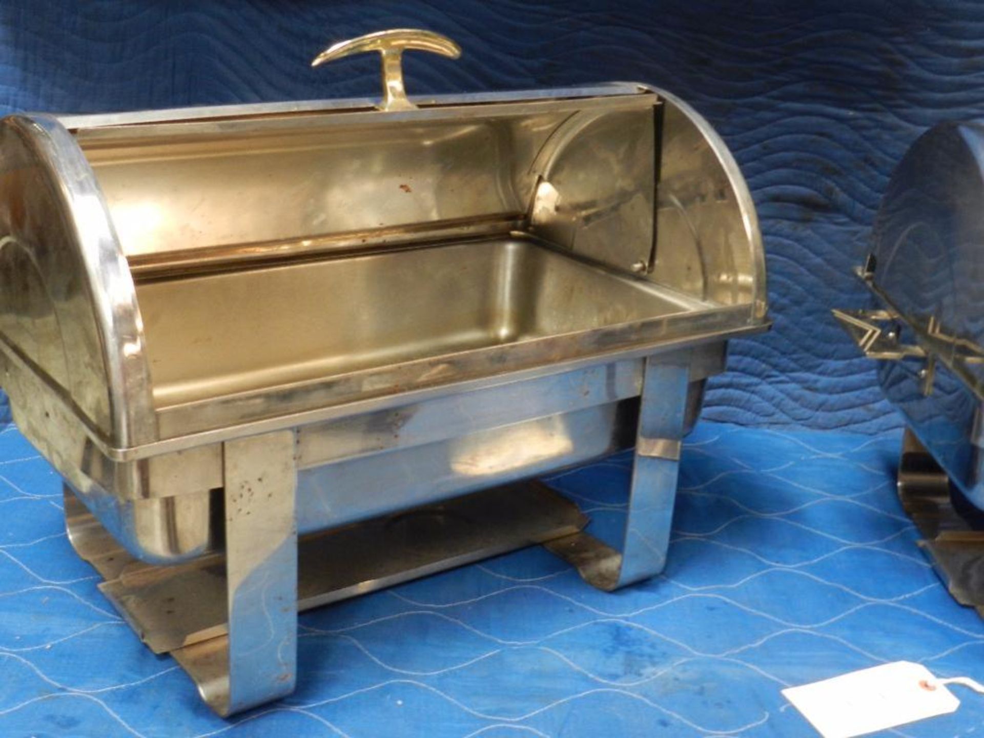 Chafing dish raised base side roll top. votive type burners. seems stainless steel. Qty two. Bid ind