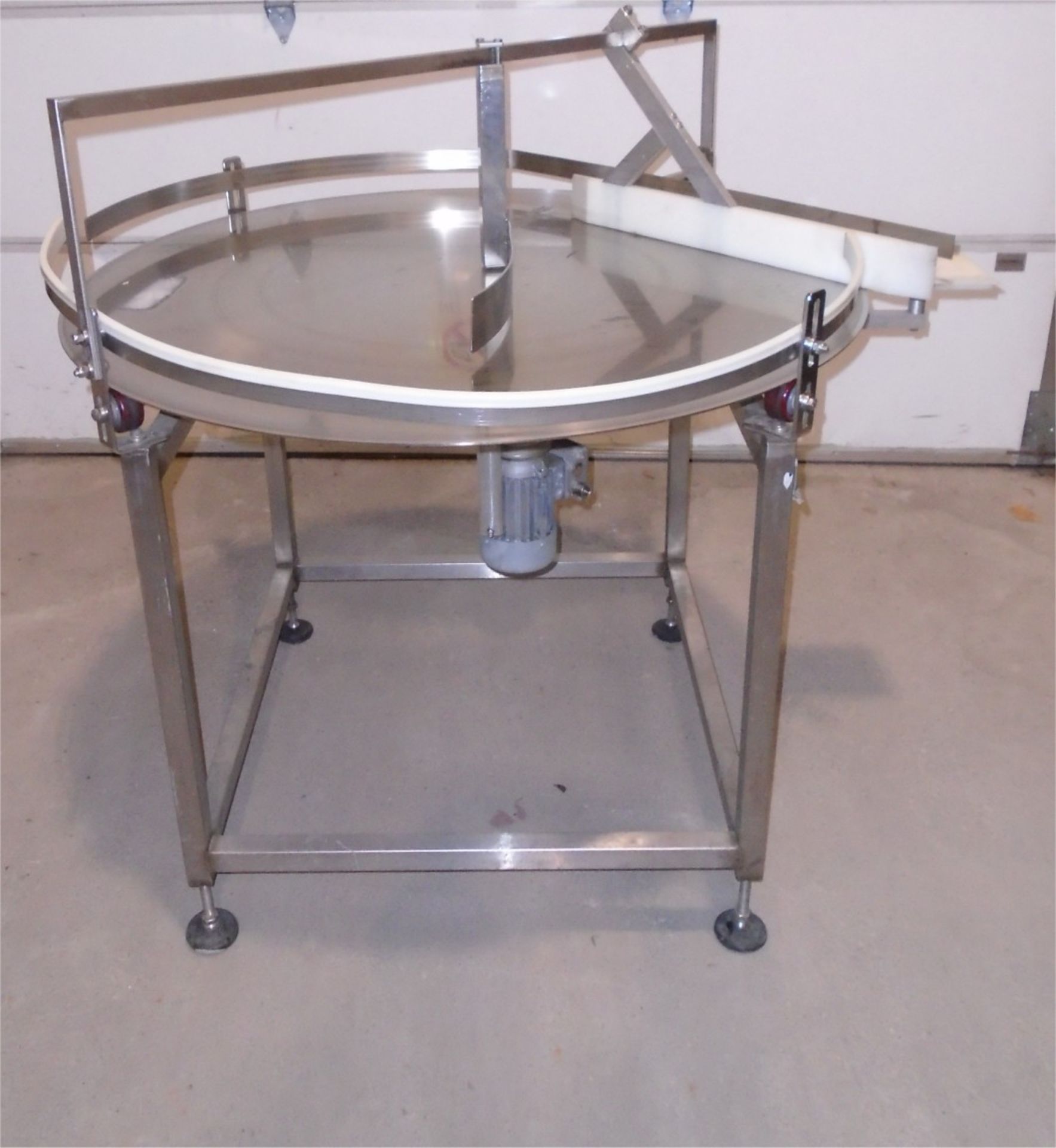 Used 48" Stainless Steel Feed Table. Height adjustable leveling legs. Electrics: 1Ph/60Hz/110Volts