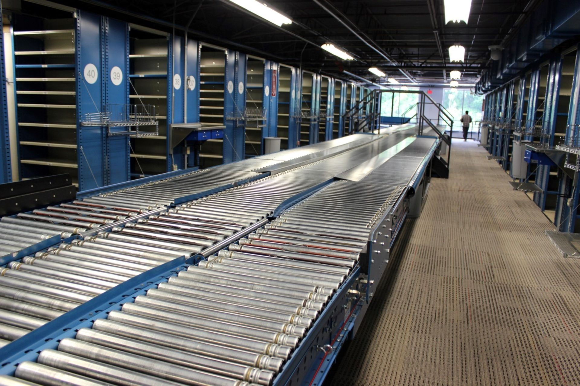 30 FT LONG 24"W RAPISTAN POWERED CONVEYOR WITH 18"W GRAVITY CONVEYOR LINES BOTH SIDES