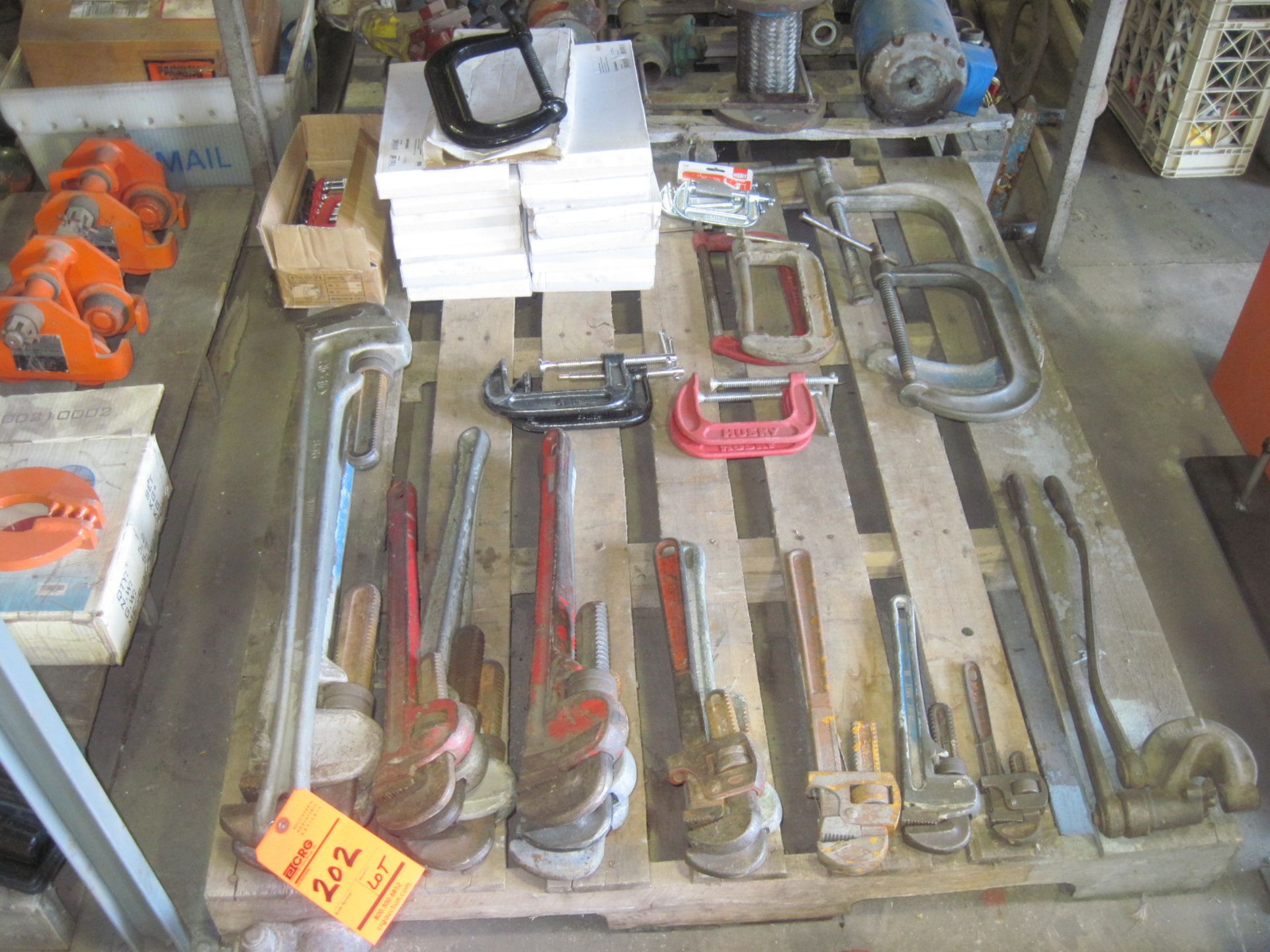 Lot of contents of skid including pipe wrenches, C-clamps & aluminum pipe wrenches