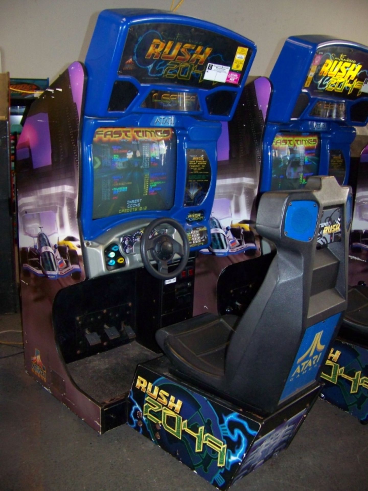 RUSH 2049 SITDOWN RACING ARCADE GAME ATARI Item is in used condition. Evidence of wear and