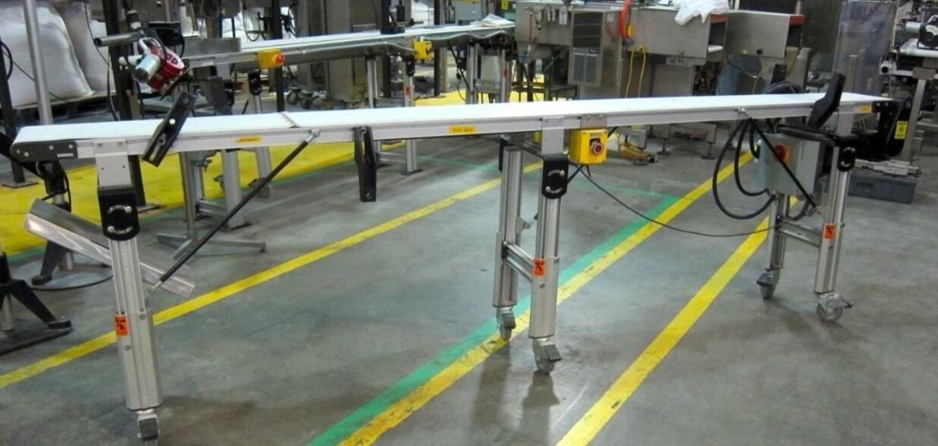 Dorner 2200 series aluminum conveyor with a thin plastic belt