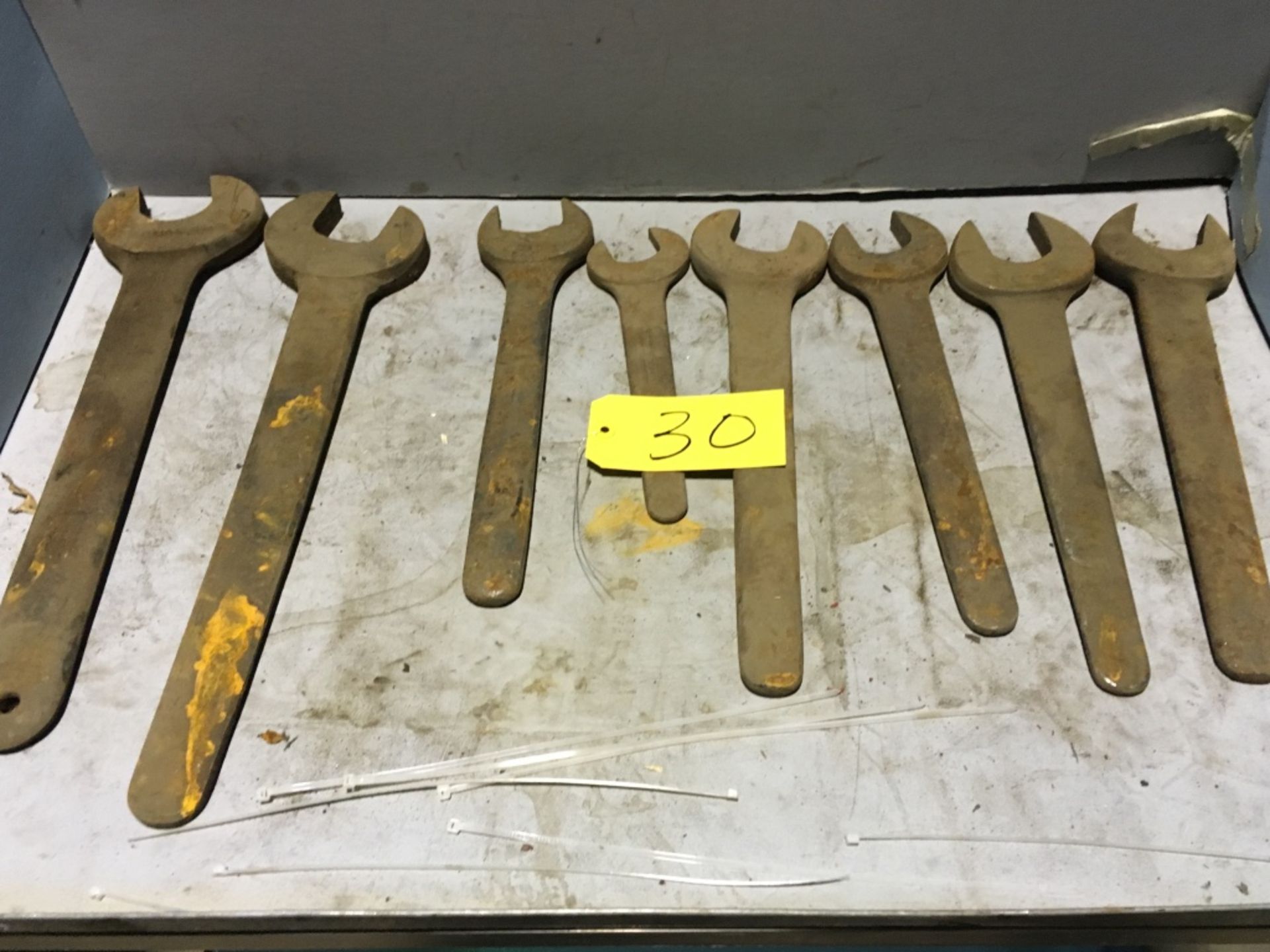 Approximately (11) open end wrenches.