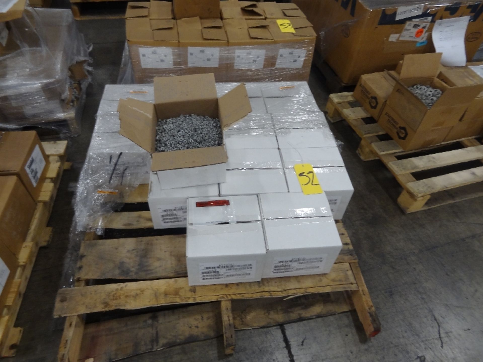 Pallet of New Boxes of Flanged Nuts