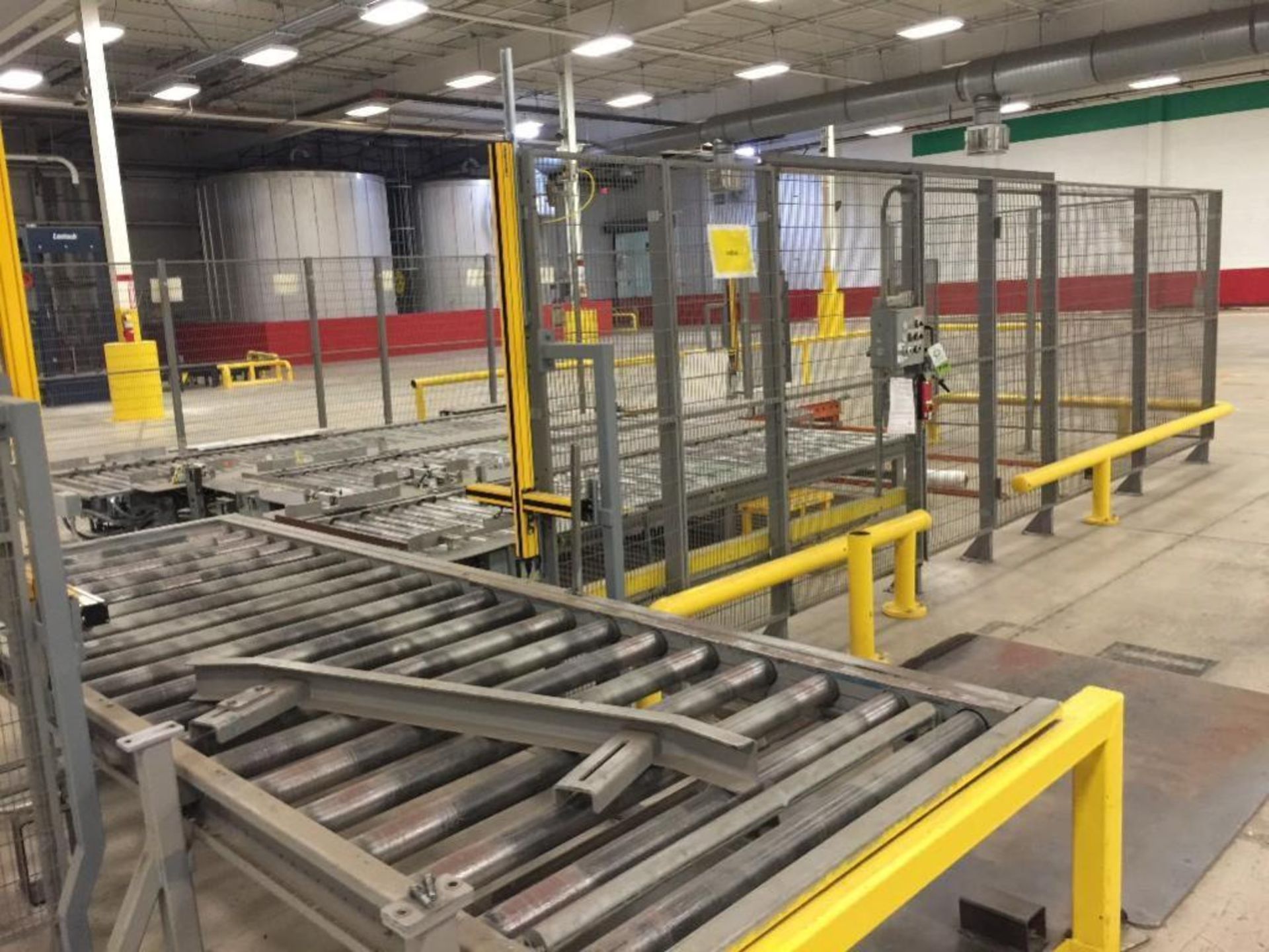 Automated Pallet Transfer System with Roller Conveyor Safety Guard Cage The fully automated pallet