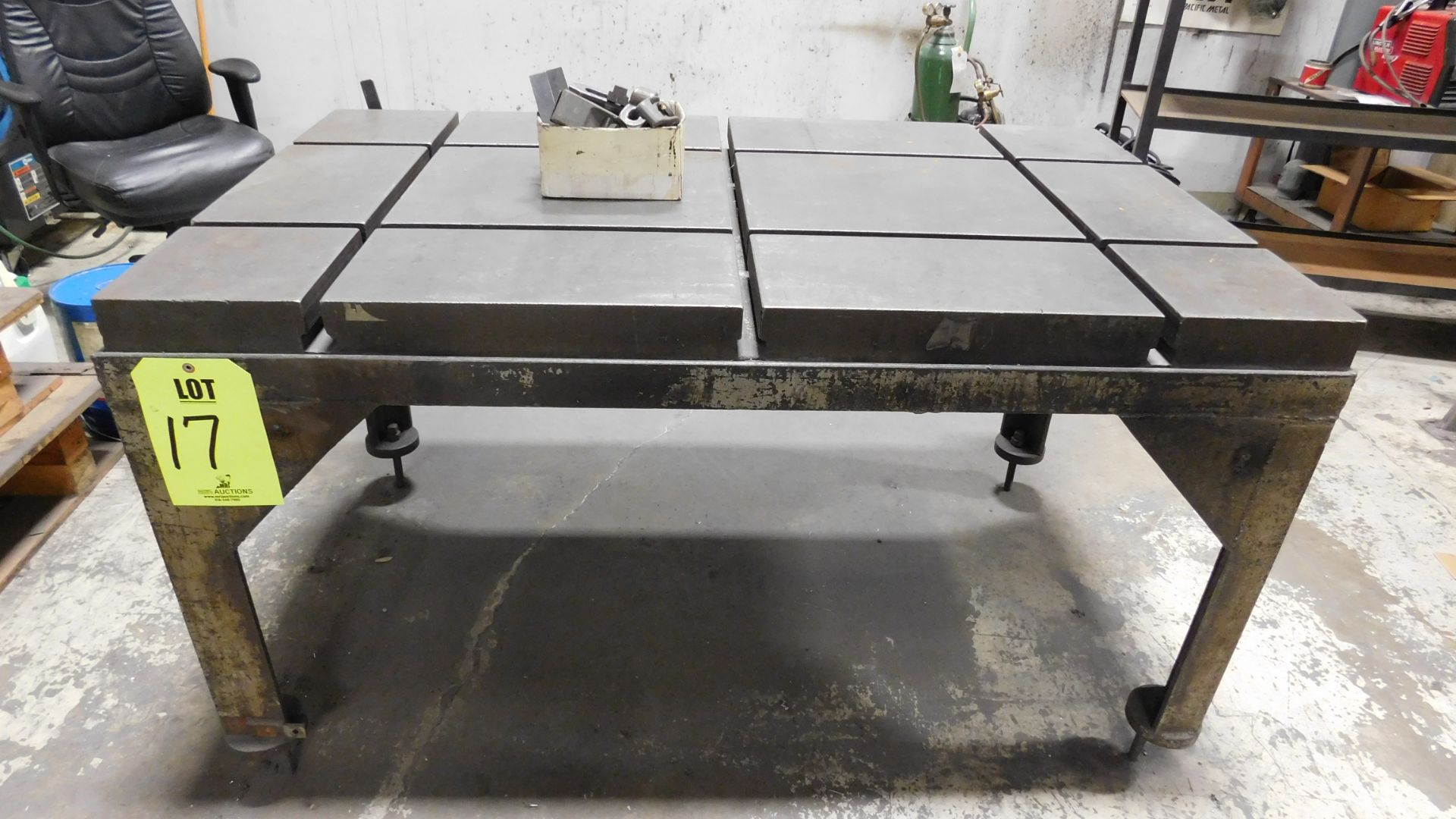 WELDING TABLE, SEGMENTED FOR CLAMPS, TOP DIA: 5' X 3' X 2-1/2", ADJUSTABLE HEIGHT, W/BOX OF MISC.