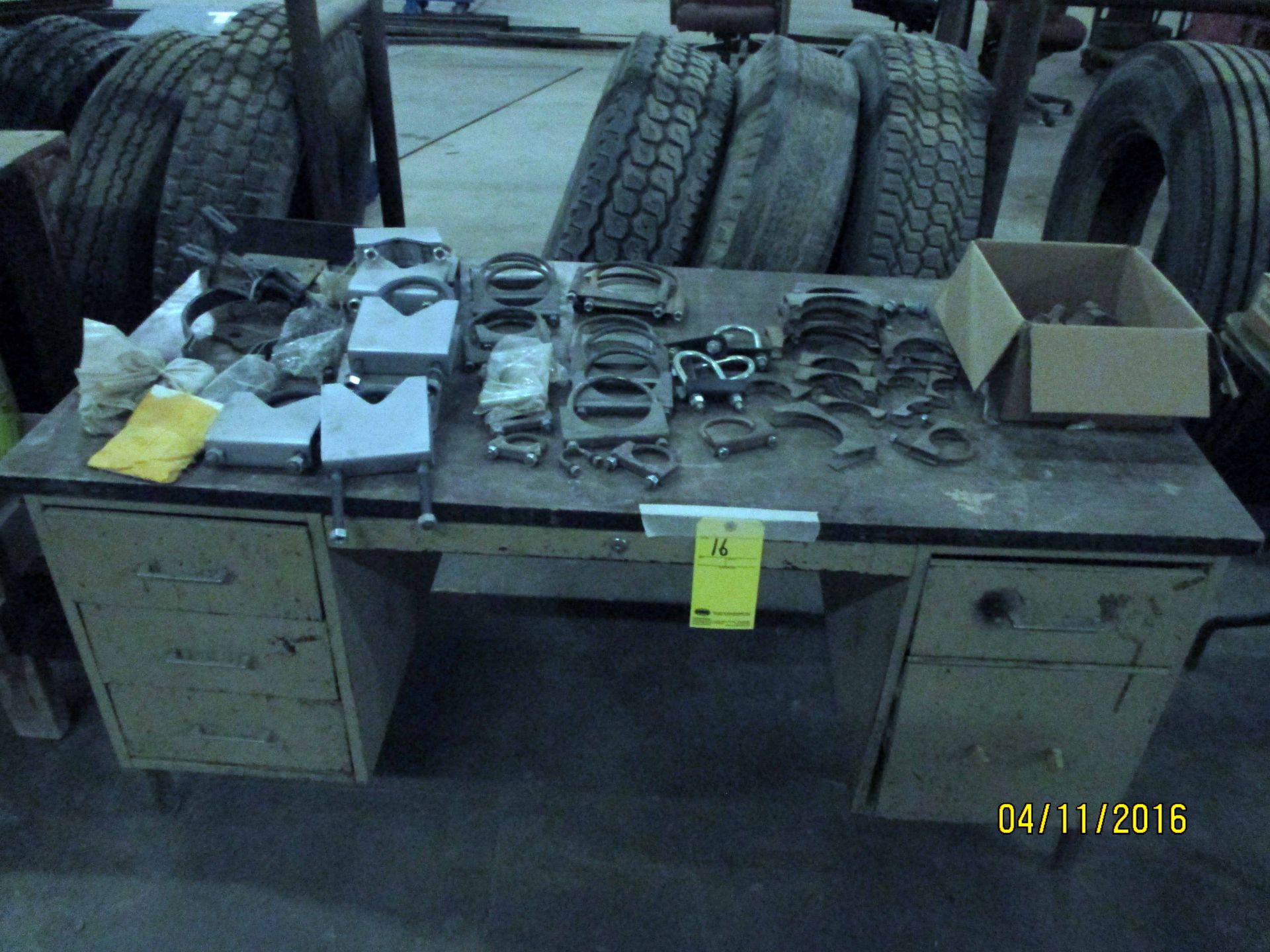 LOT CONSISTING OF: muffler clamps & 5th wheel jaws (on one desk)