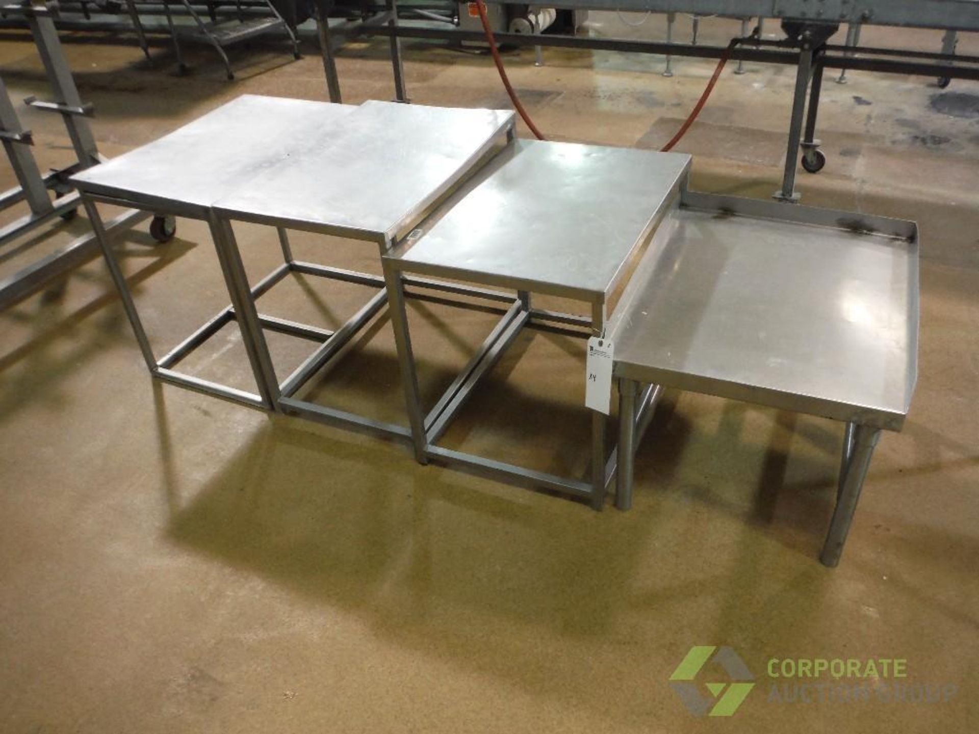 (4) assorted SS tables, approx. 30 in. long x 21 in. wide x 26 in. tall (LOT)