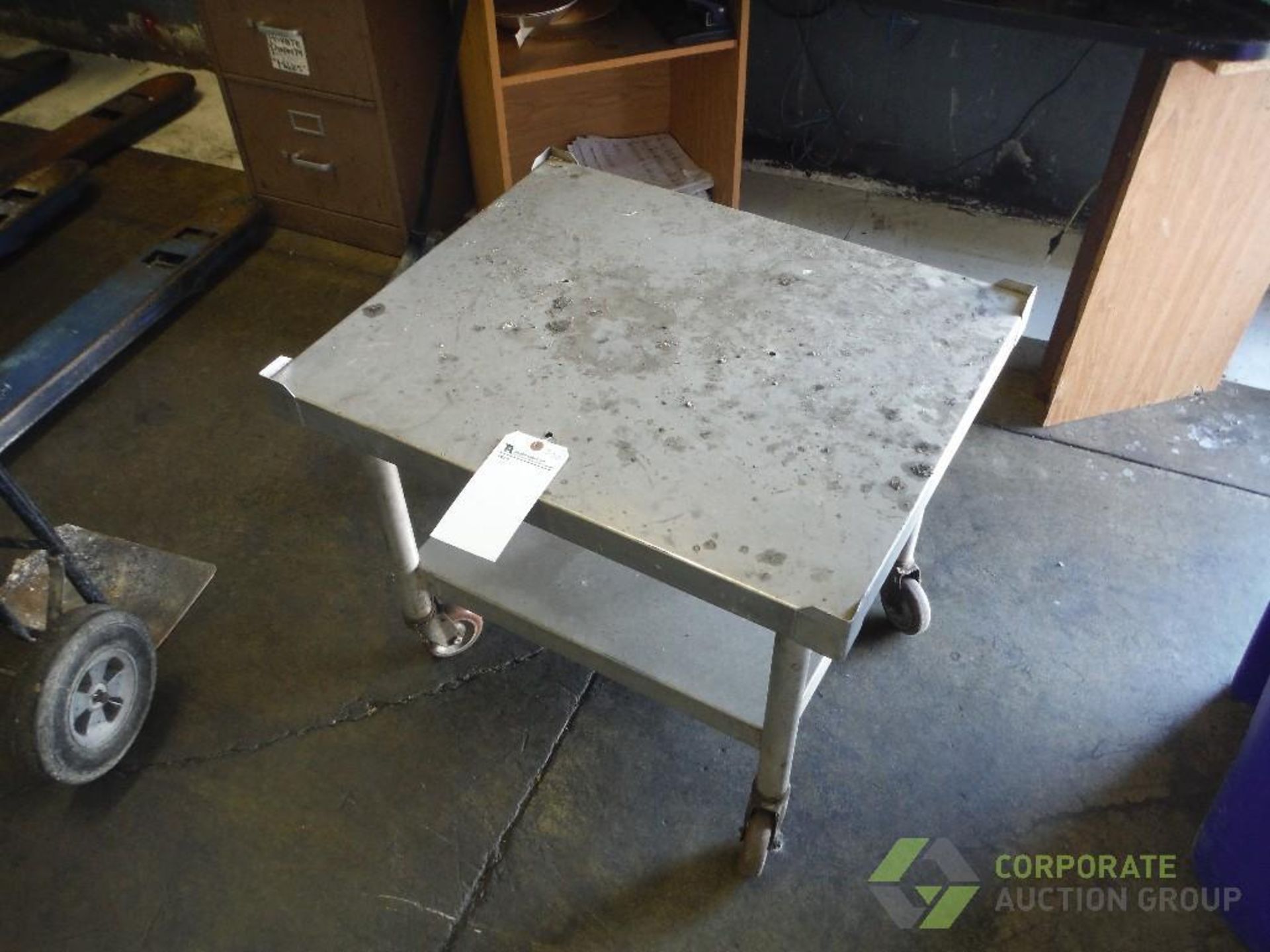 SS table, 30 in. long x 24 in. wide x 24 in. wide, mild steel legs, on casters