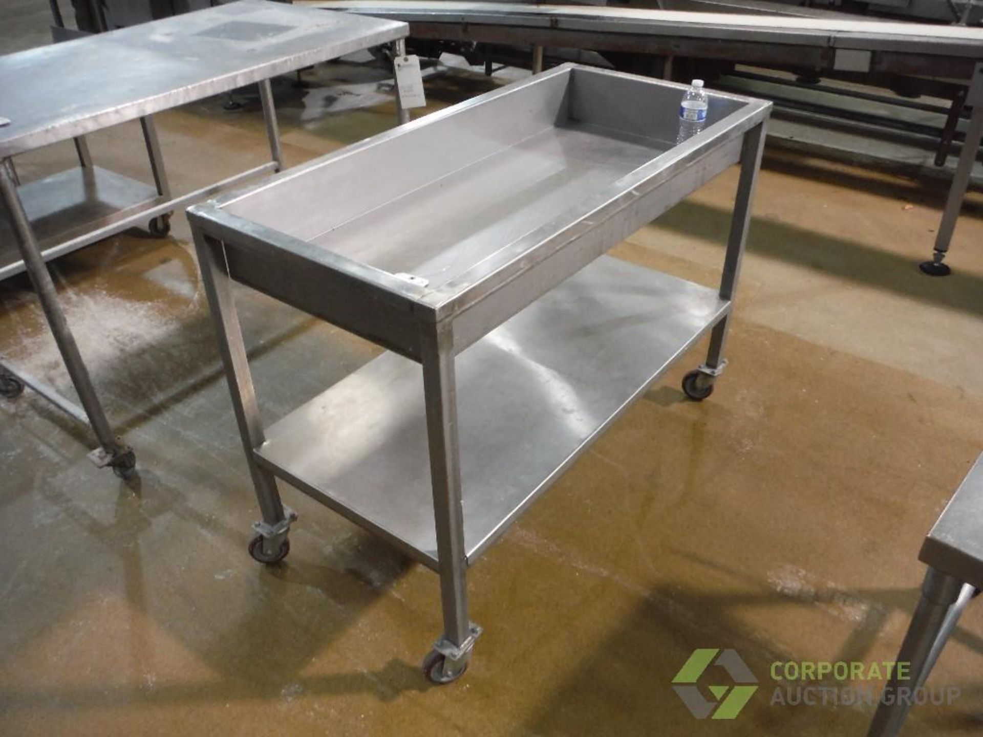 SS parts table, 48 in. long x 21 in. wide x 6 in. deep x 38 in. tall, on casters