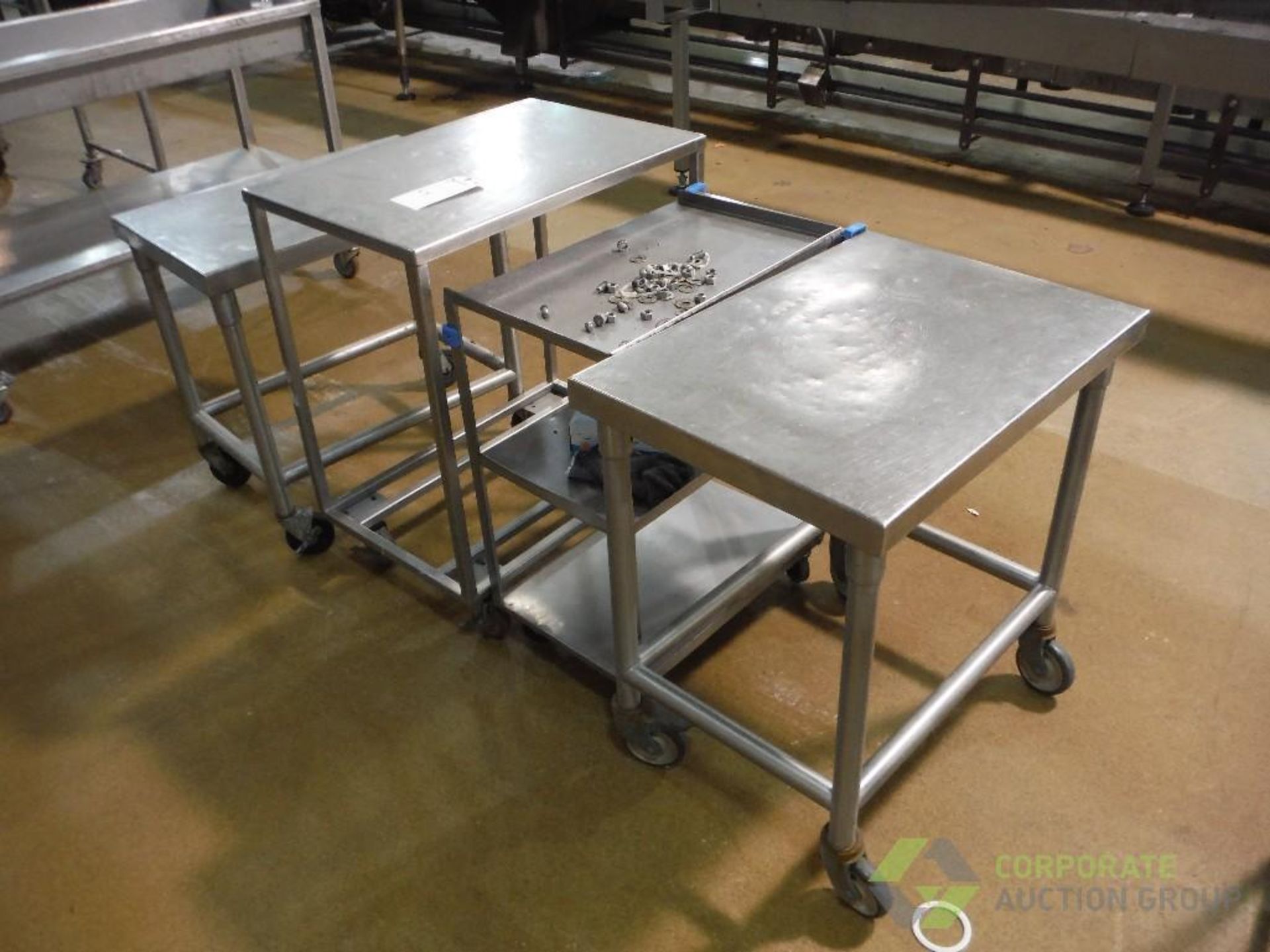 (4) assorted SS tables, approx. 30 in. long x 21 in. wide x 30 in. tall, on casters (LOT) - Image 2 of 2