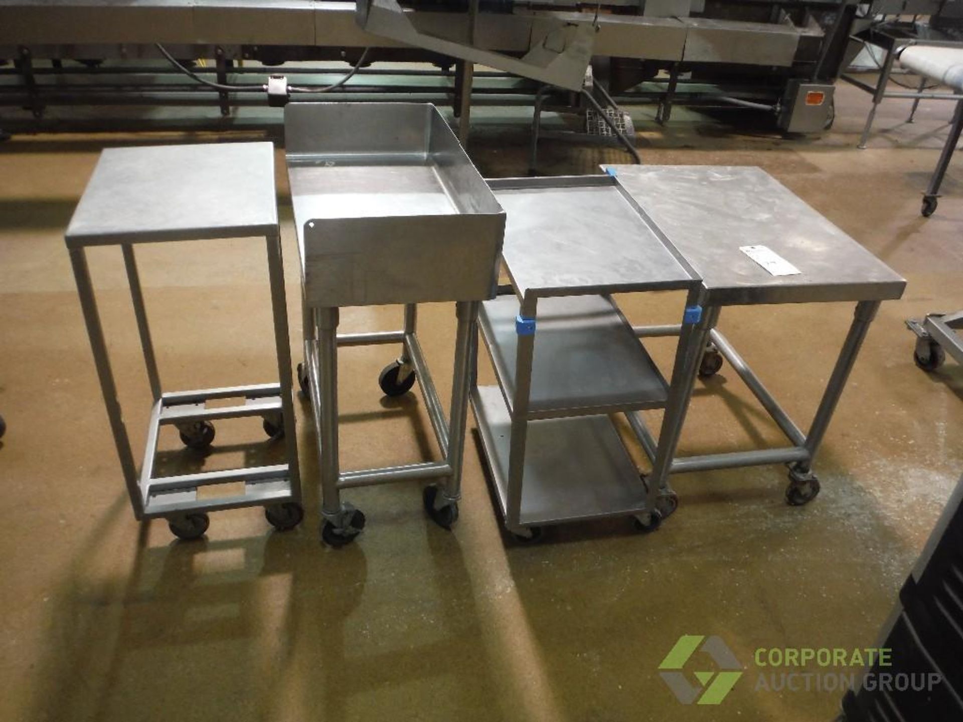 (4) assorted SS tables, approx. 30 in. long x 21 in. wide x 30 in. tall, on casters (LOT)