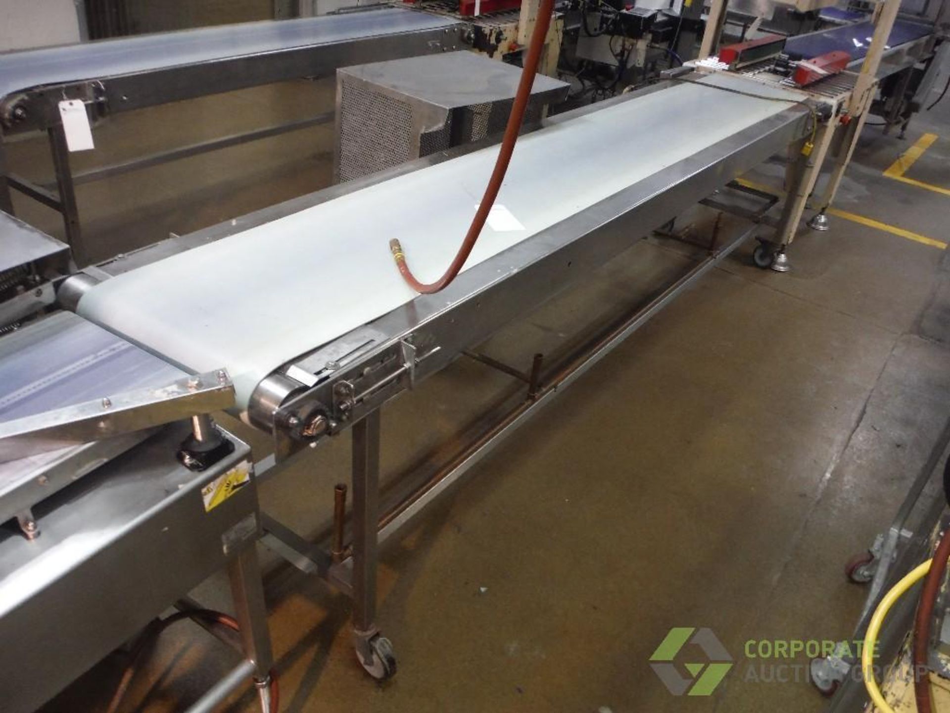 Belt conveyor, 130 in. long x 23 in. wide x 35 in. tall, SS frame, motor and drive, on casters,