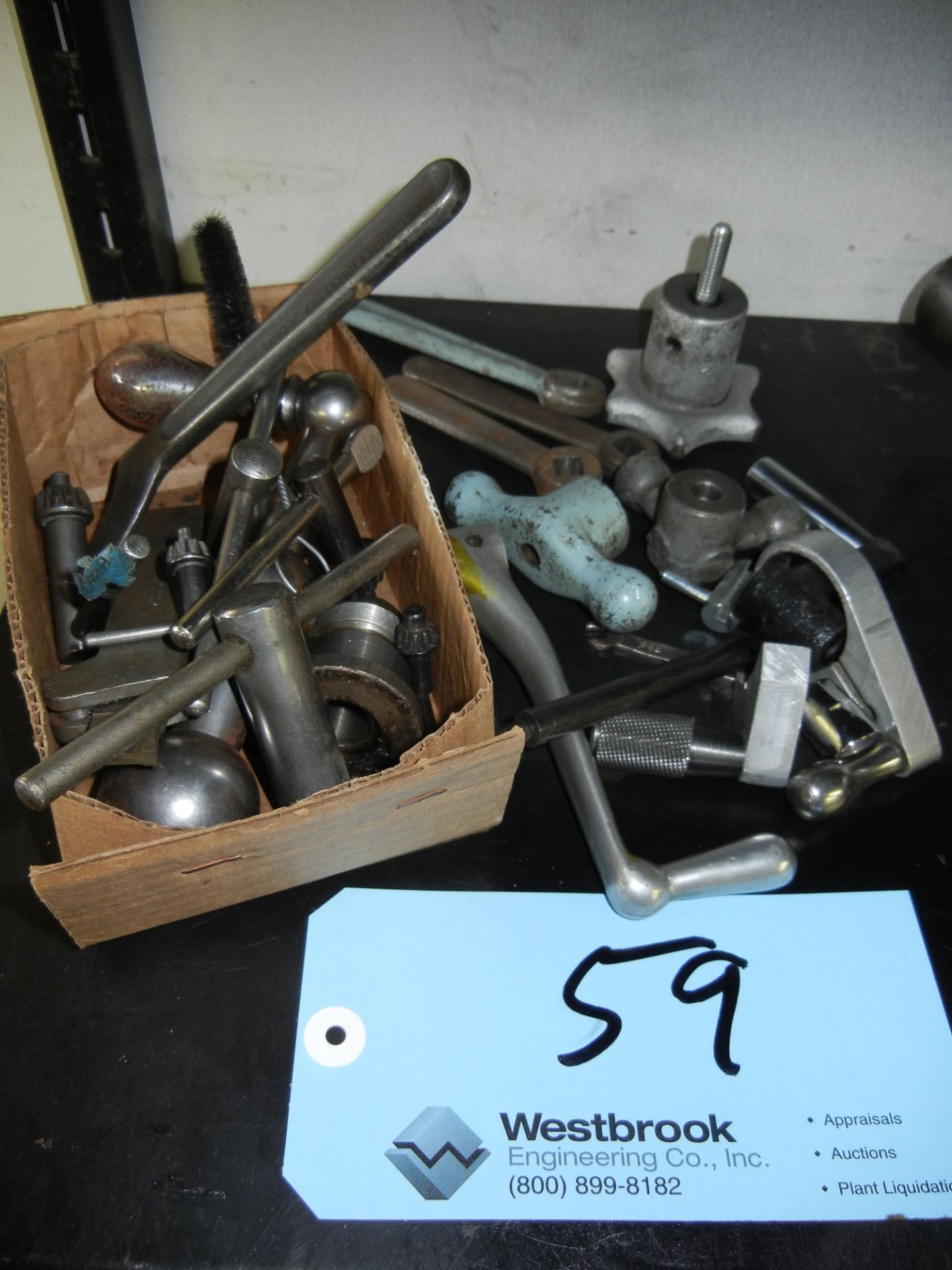 Assortment of machine handles and chuck keys on shelf (shelf not included)