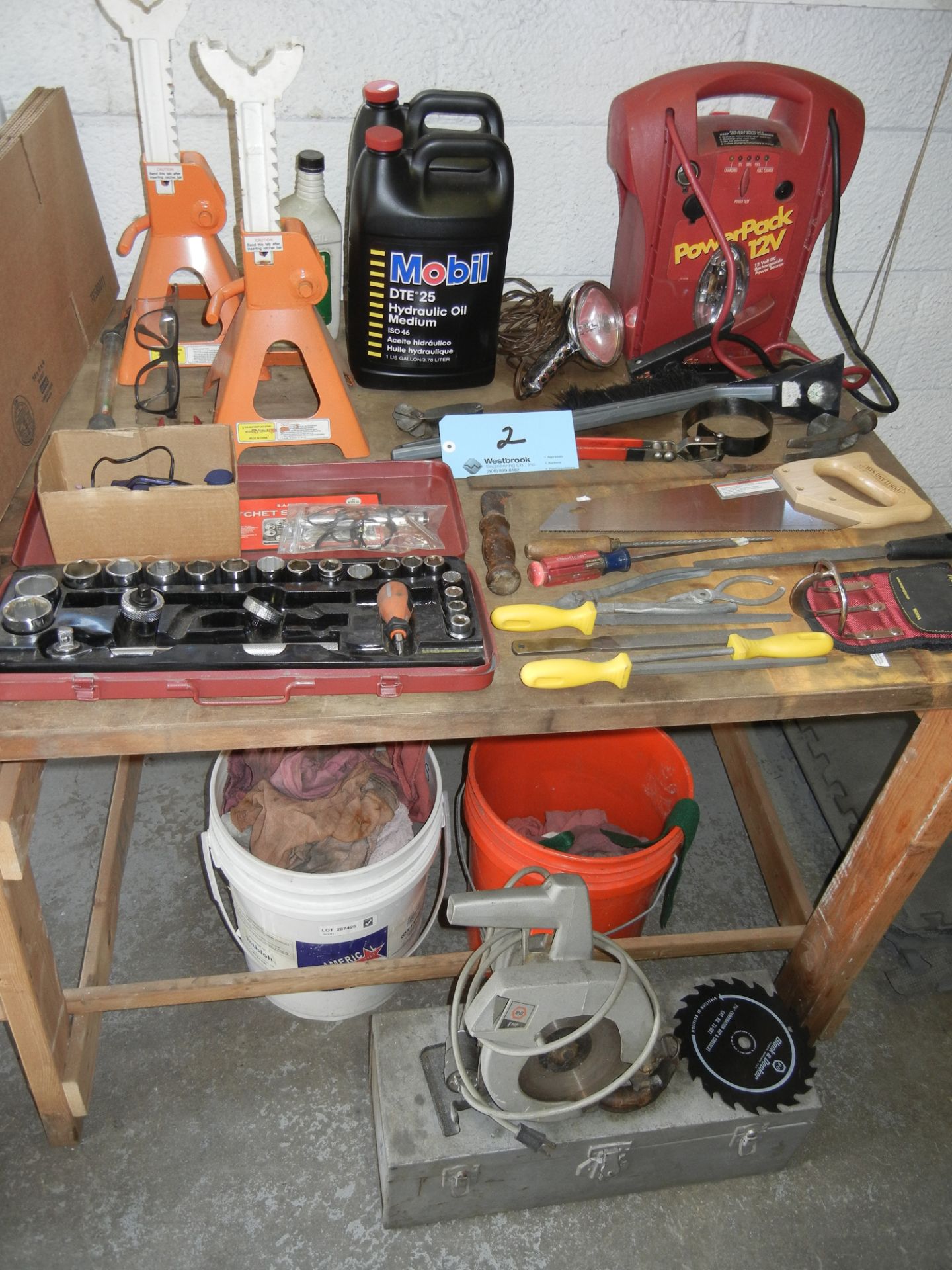 Hand tools, car accessories on top and below table, tool box, circular saw