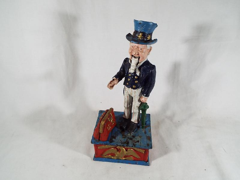 A cast iron money bank in the form of Uncle Sam,