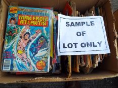 A box containing a collection of unsorted comics, magazines, children's annuals and similar,