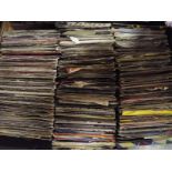 A box containing in excess of 200 vinyl single records predominantly pop music from 1970's and