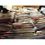 A box containing in excess of 200 vinyl single records predominantly pop and rock music from the