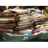 A box containing in excess of 200 vinyl single records predominantly pop and rock music from the