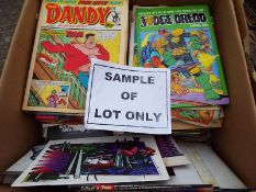 A box containing a collection of unsorted comics, magazines, children's annuals and similar,