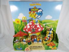 Ronald McDonald Happy Meal Point of Sale display stand containing ten Smurf characters