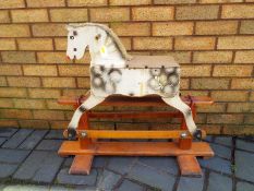 A vintage child's wooden rocking horse approximately 67 cm (h) x 70 cm (w) x 26 cm (d)