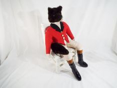 A dressed Fox seated in a miniature rush seated chair,