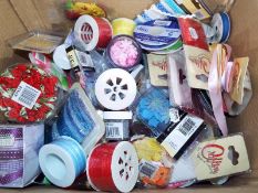 A large quantity of predominantly unused craft and hobby accessories to include ribbons, flowers,