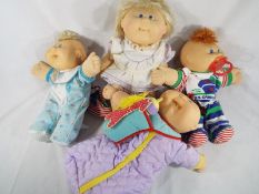 Four Cabbage Patch dolls