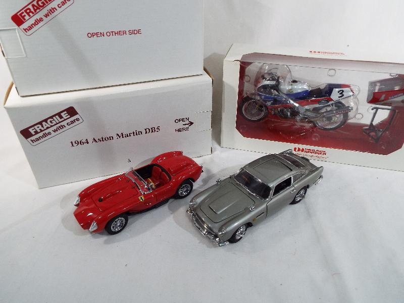 Danbury Mint - two diecast 1:24 scale models depicting a James Bond 007 Aston Martin DB5 replica of