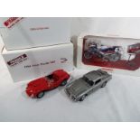 Danbury Mint - two diecast 1:24 scale models depicting a James Bond 007 Aston Martin DB5 replica of