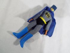 Batman - a doll depicting Batman with blue cape,