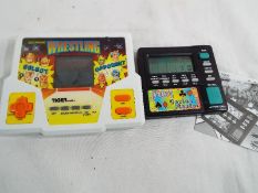 A LCD hand held electronic Wrestling game by Tiger (1988) and a 7 in 1 Casino Master game with