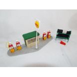 Dinky Toys - a Petrol Pump Station, Shell, comprising paved base, sign, kiosk, four pumps,