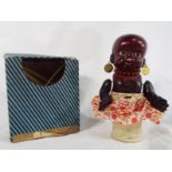 A small celluloid black doll, marked IN to middle of back, yellow metal earrings marked "Patent",