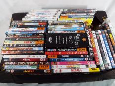 A collection of approximately 53 DVDs to include Chick flicks, action movies,