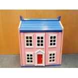 A wooden front opening doll's house with