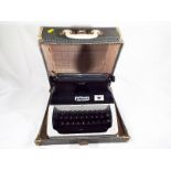 A Lilliput typewriter with travel case (