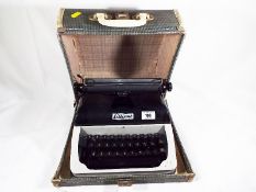 A Lilliput typewriter with travel case (