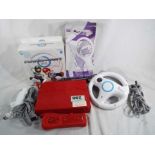 A Nintendo Wii with steering wheel and accessories